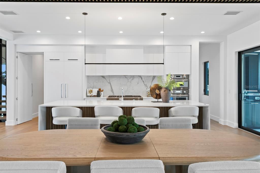 Dining room, Interior, Kitchen, Marble Walls, Pendant Lights, Recessed Lighting, Stainless Steel Appliances, Wood Texture Flooring