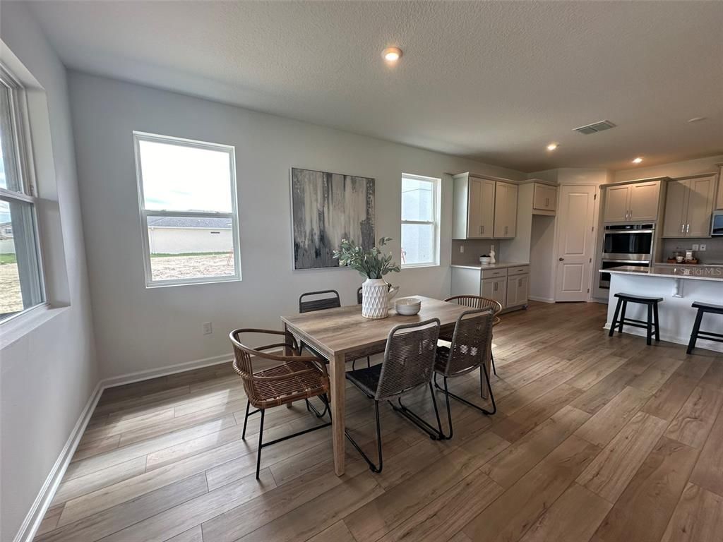 Dining room, Interior, Kitchen, Recessed Lighting, Stainless Steel Appliances, Wood Texture Flooring