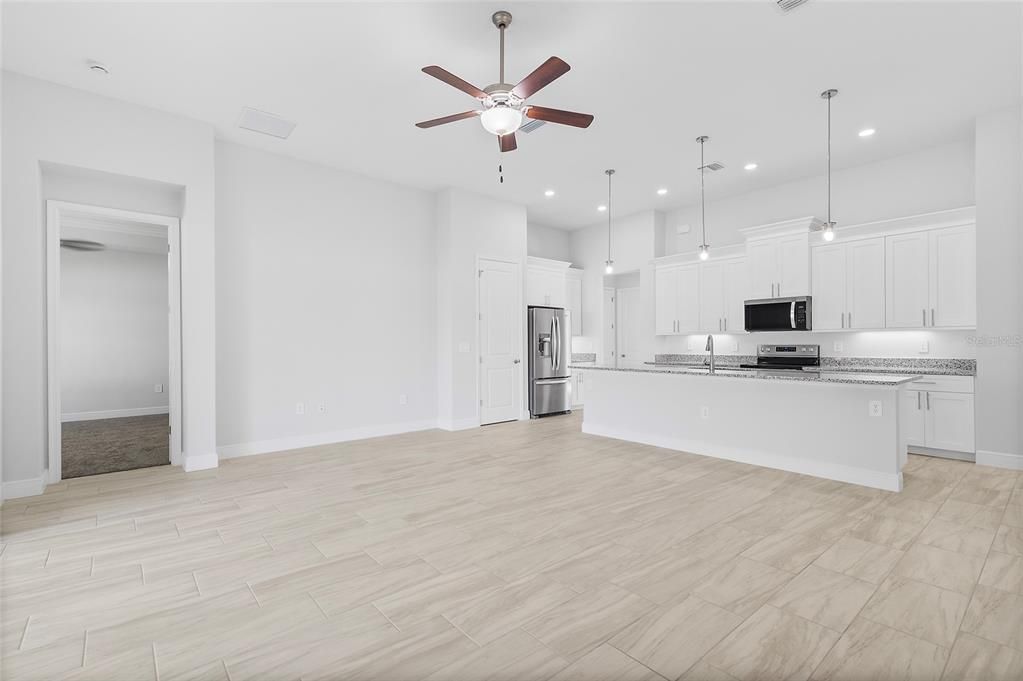 Empty room, Interior, Kitchen, Pendant Lights, Recessed Lighting, Stainless Steel Appliances, Wood Texture Flooring