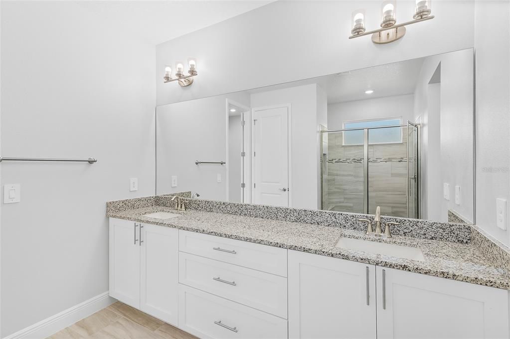 Bathroom, Dual Sink Vanities, Glass Shower, Interior, Recessed Lighting, Wood Texture Flooring
