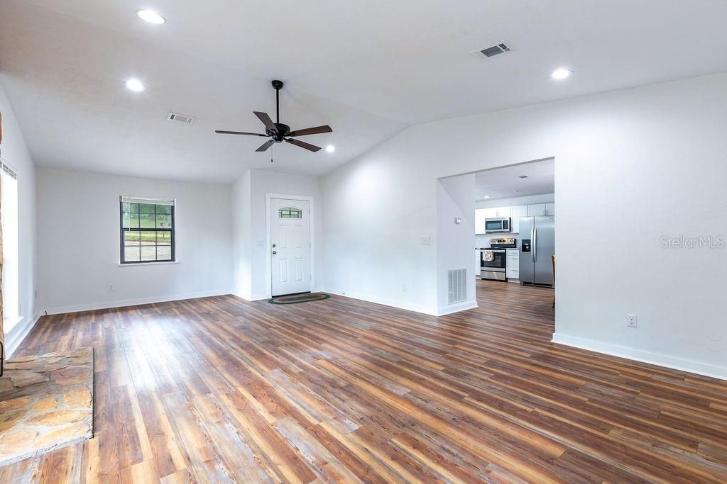 Empty room, Interior, Kitchen, Recessed Lighting, Stainless Steel Appliances, Wood Texture Flooring