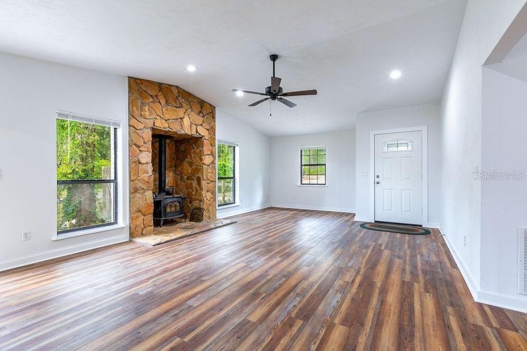 Empty room, Fireplace, Interior, Recessed Lighting, Stone Walls, Wood Texture Flooring