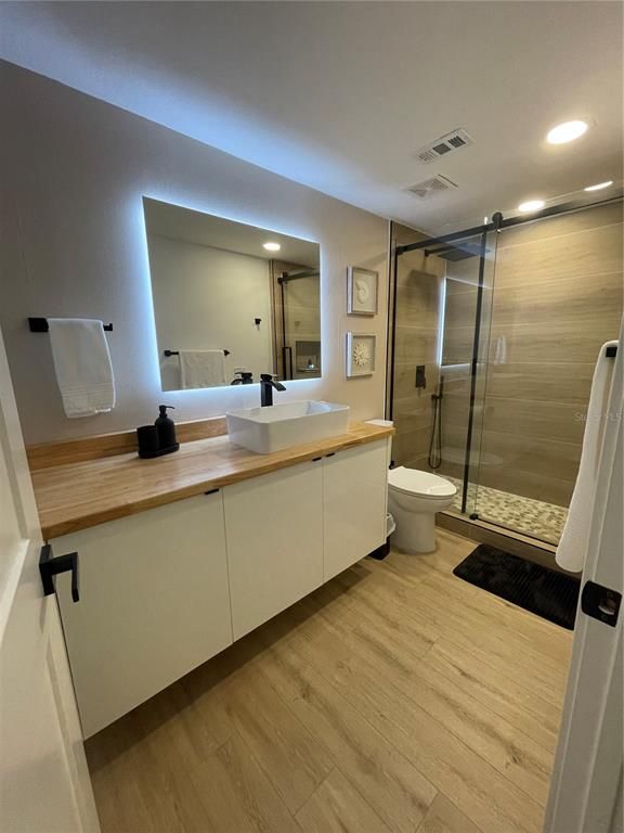 Bathroom, Dual Sink Vanities, Glass Shower, Interior, Recessed Lighting, Wood Texture Flooring