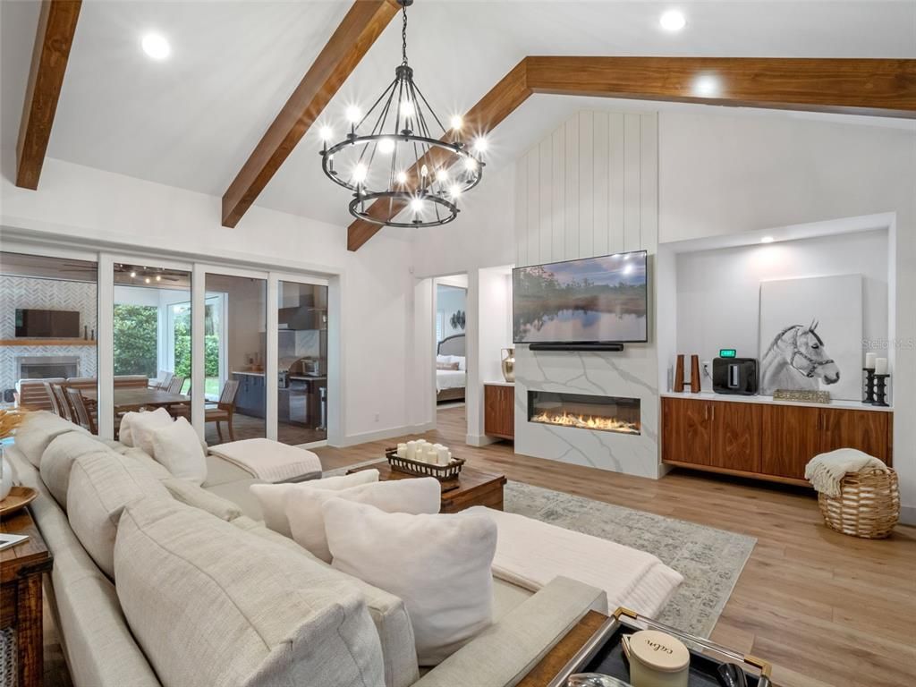 Chandelier, Dining room, Fireplace, Interior, Living room, Pendant Lights, Recessed Lighting, Wooden Beams, Wood Texture Flooring
