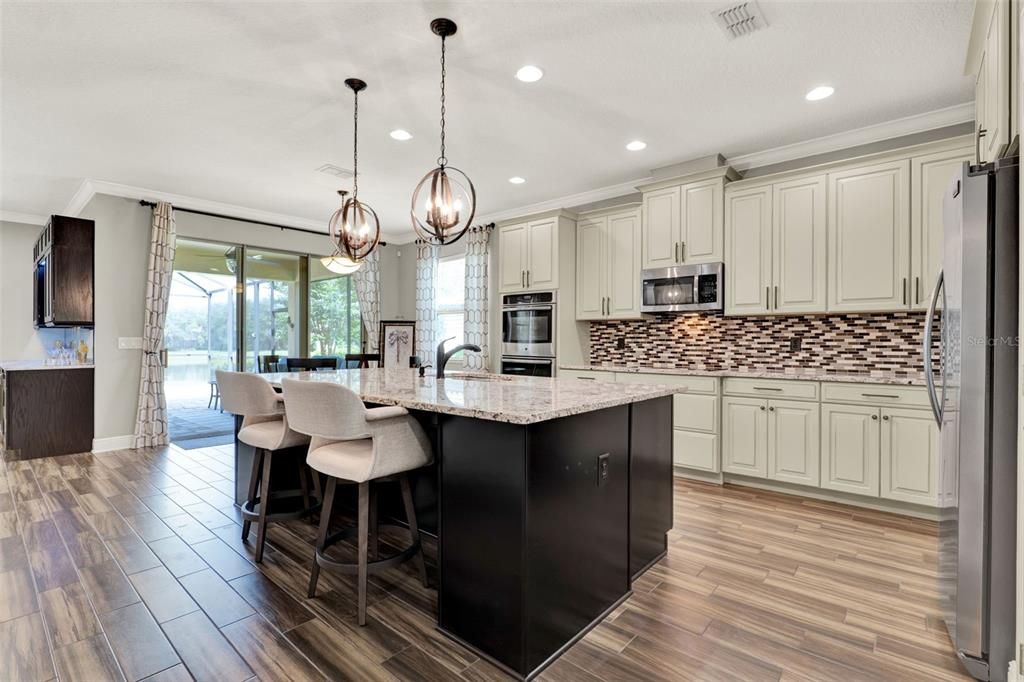 Dining room, Interior, Kitchen, Pendant Lights, Recessed Lighting, Stainless Steel Appliances, Wood Texture Flooring
