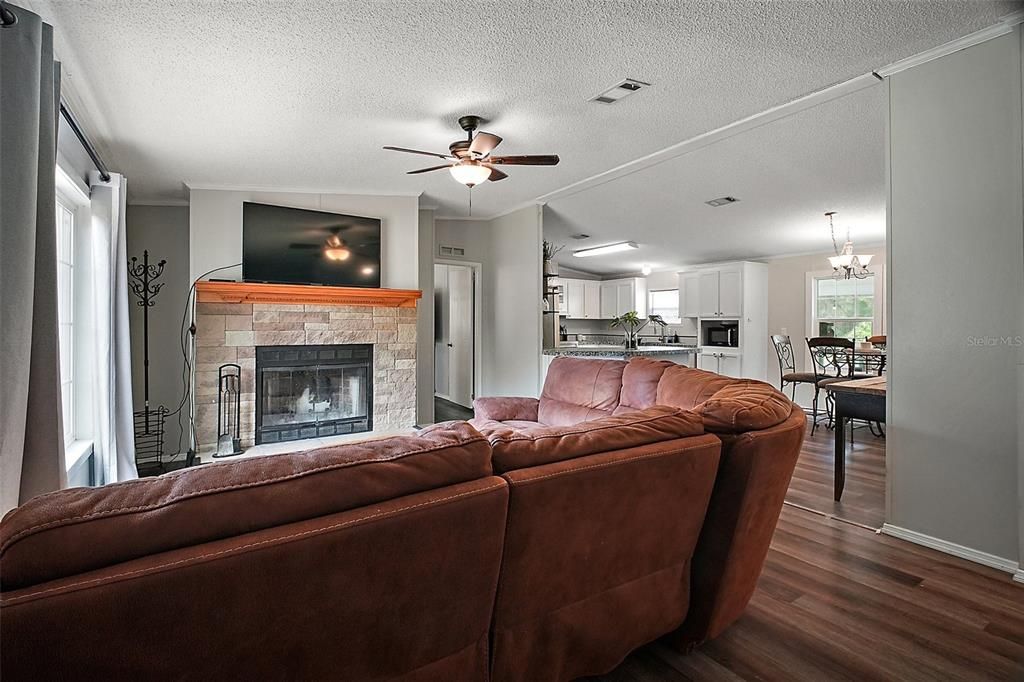 Chandelier, Dining room, Fireplace, Interior, Kitchen, Living room, Stainless Steel Appliances, Wood Texture Flooring