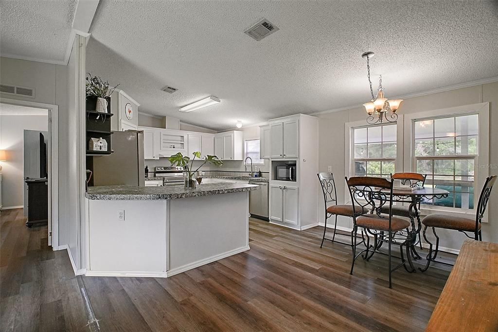 Chandelier, Dining room, Interior, Kitchen, Stainless Steel Appliances, Wood Texture Flooring