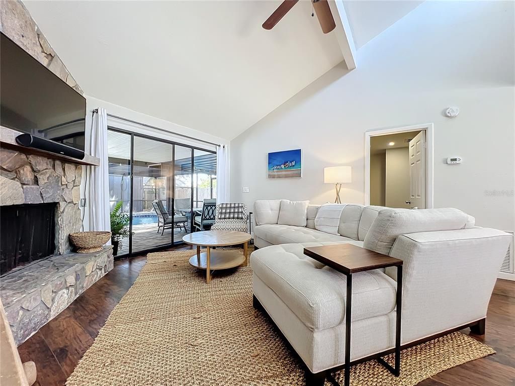 Fireplace, Interior, Living room, Recessed Lighting, Stone Walls, Wood Texture Flooring