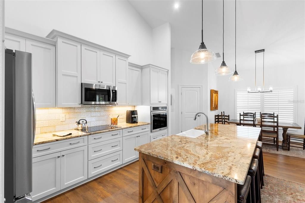 Dining room, Interior, Kitchen, Pendant Lights, Recessed Lighting, Stainless Steel Appliances, Wood Texture Flooring