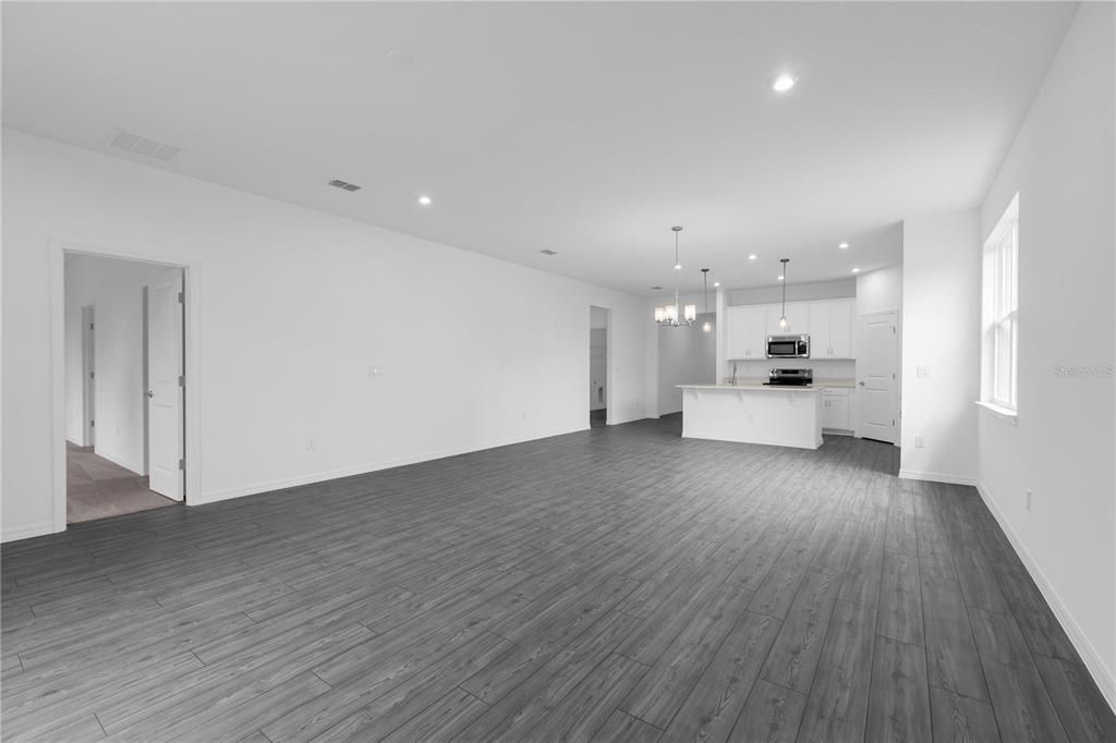 Empty room, Interior, Kitchen, Pendant Lights, Recessed Lighting, Stainless Steel Appliances, Wood Texture Flooring