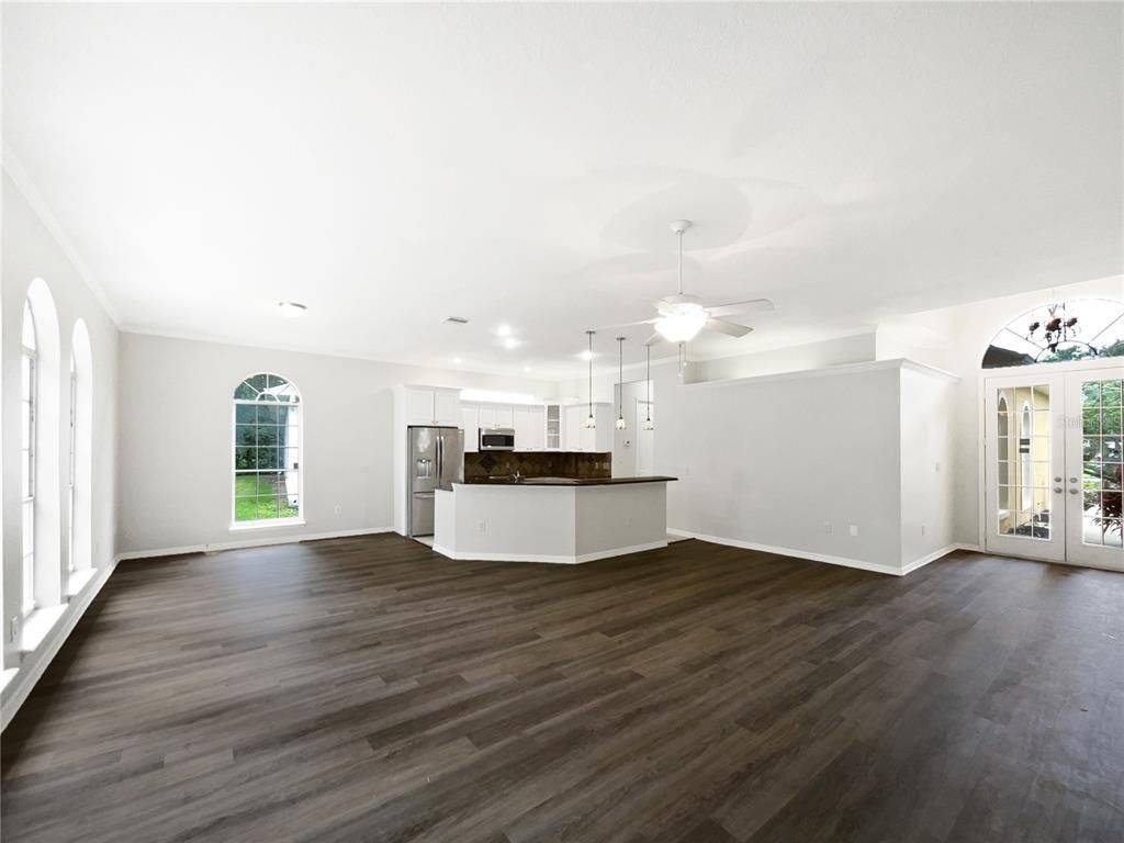 Empty room, Interior, Kitchen, Pendant Lights, Recessed Lighting, Stainless Steel Appliances, Wood Texture Flooring
