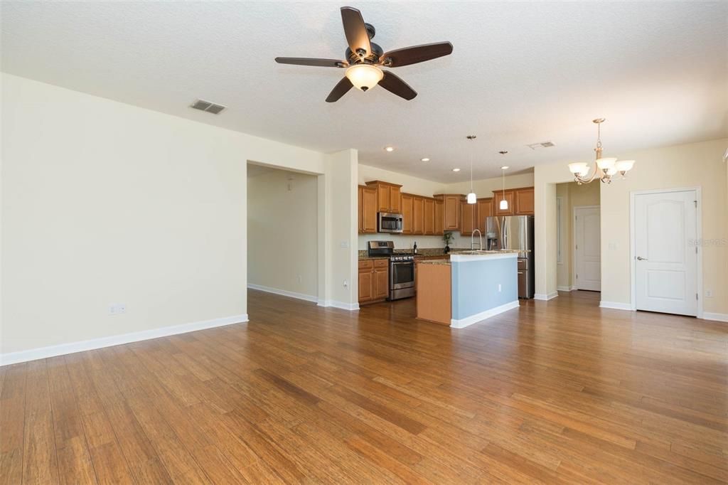 Chandelier, Empty room, Interior, Kitchen, Pendant Lights, Recessed Lighting, Stainless Steel Appliances, Wood Texture Flooring