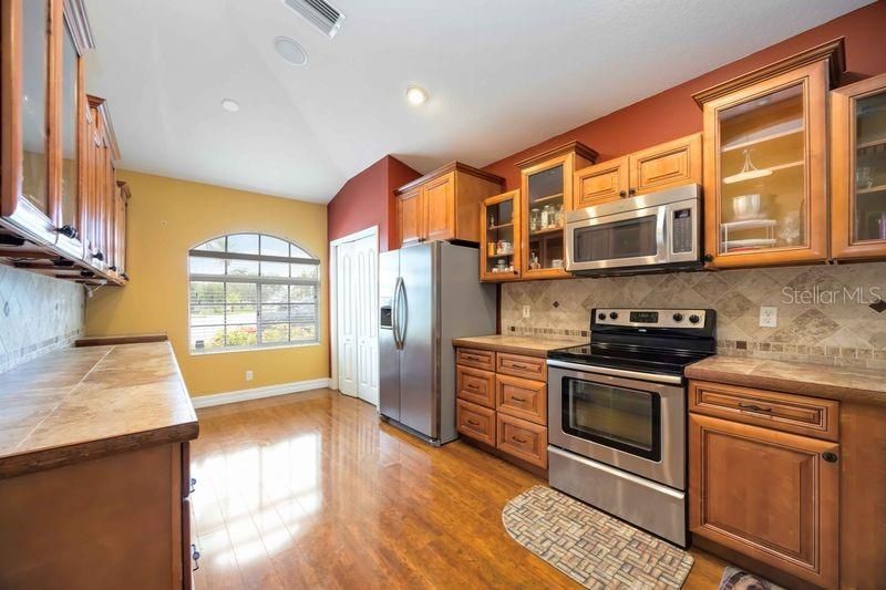 Interior, Kitchen, Recessed Lighting, Stainless Steel Appliances, Tile Countertops, Wood Texture Flooring