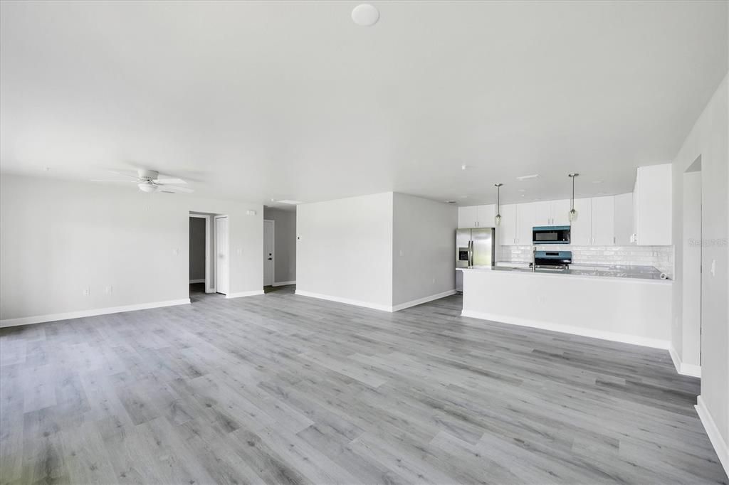 Empty room, Interior, Kitchen, Pendant Lights, Stainless Steel Appliances, Wood Texture Flooring