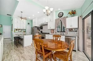 Chandelier, Dining room, Interior, Kitchen, Marble, Recessed Lighting, Stainless Steel Appliances, Wood Texture Flooring