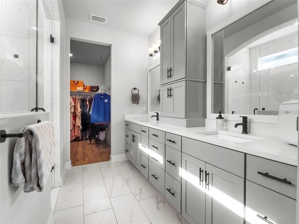 Bathroom, Dual Sink Vanities, Glass Shower, Interior, Marble, Walk-in Closets, Wood Texture Flooring