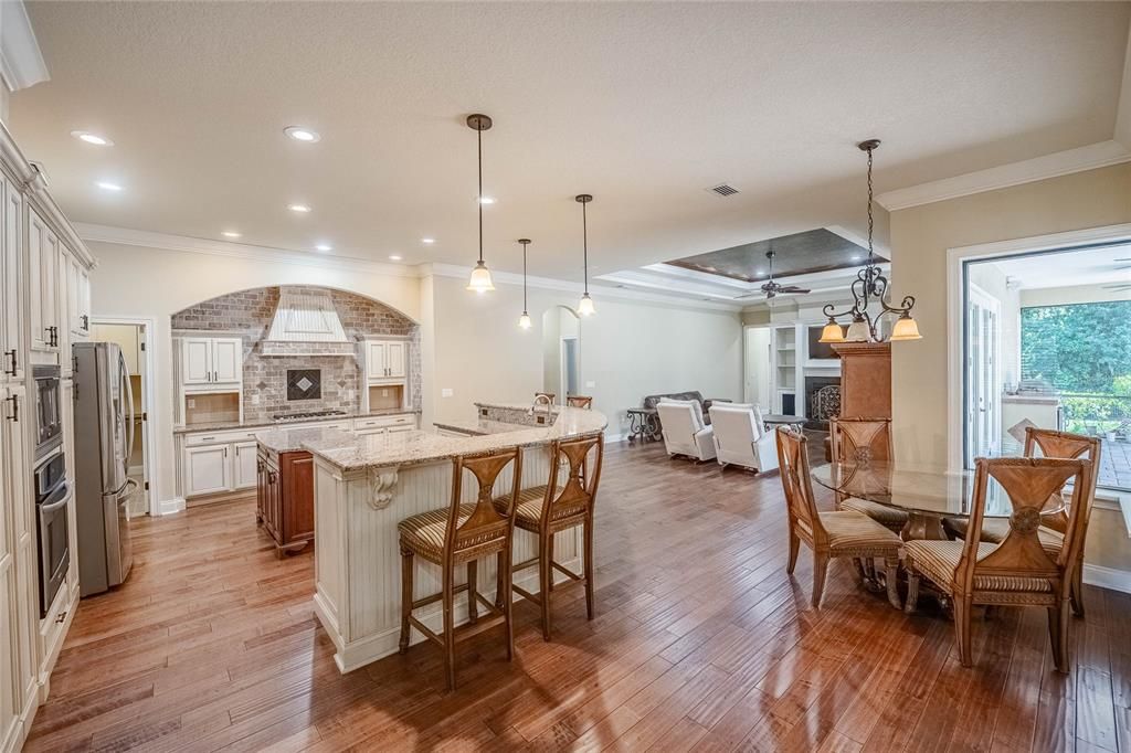 Dining room, Fireplace, Interior, Kitchen, Living room, Pendant Lights, Recessed Lighting, Stainless Steel Appliances, Wood Texture Flooring