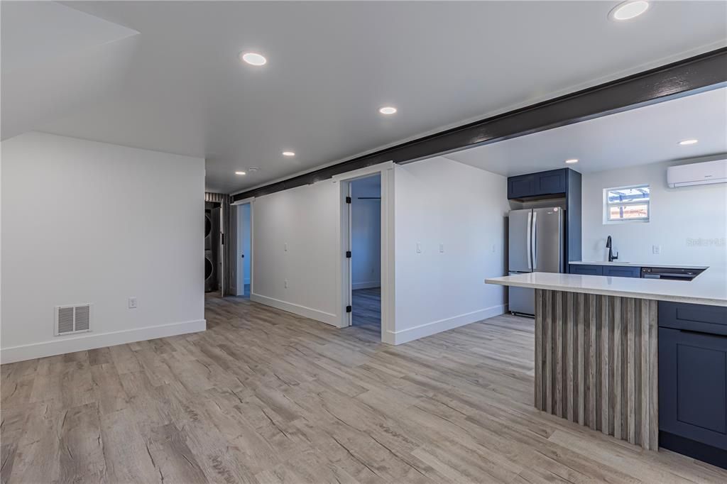 Empty room, Interior, Kitchen, Recessed Lighting, Stainless Steel Appliances, Wood Texture Flooring