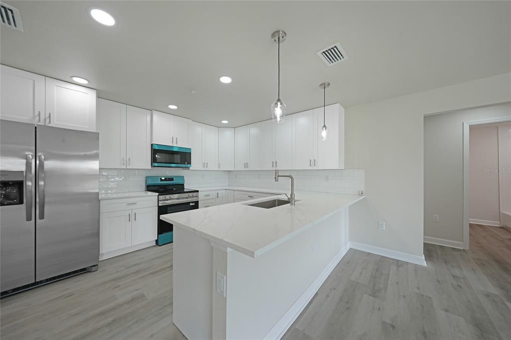 Interior, Kitchen, Pendant Lights, Recessed Lighting, Stainless Steel Appliances, Wood Texture Flooring