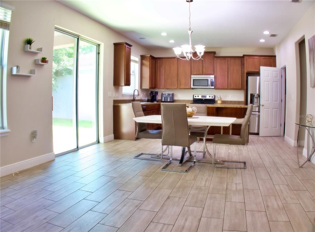 Chandelier, Dining room, Interior, Kitchen, Recessed Lighting, Stainless Steel Appliances, Wood Texture Flooring