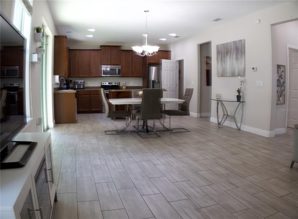 Chandelier, Dining room, Interior, Kitchen, Recessed Lighting, Stainless Steel Appliances, Wood Texture Flooring