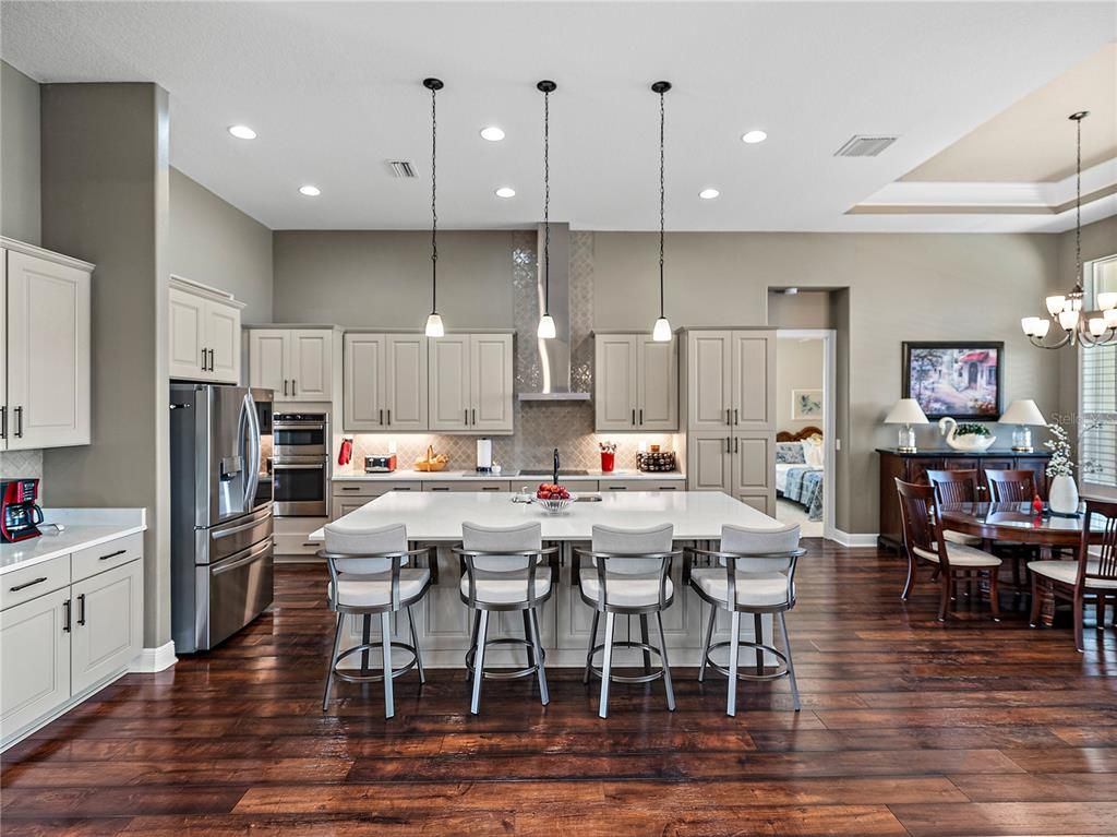 Chandelier, Dining room, Interior, Kitchen, Pendant Lights, Recessed Lighting, Stainless Steel Appliances, Wood Texture Flooring