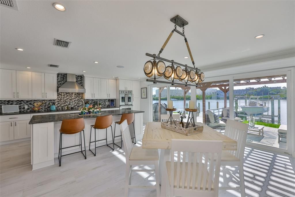 Dining room, Interior, Kitchen, Pendant Lights, Recessed Lighting, Stainless Steel Appliances, Water, Wood Texture Flooring