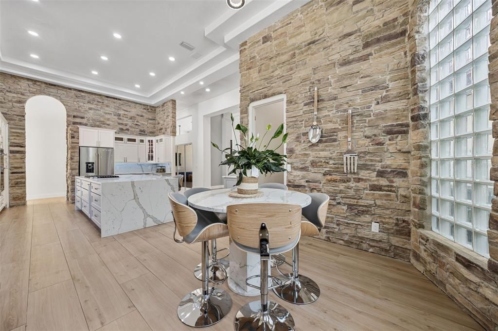 Dining room, Interior, Kitchen, Recessed Lighting, Stainless Steel Appliances, Stone Walls, Wood Texture Flooring