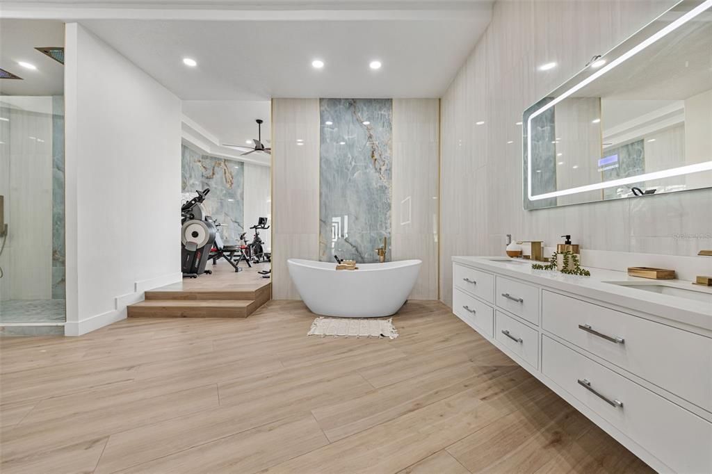 Bathroom, Dual Sink Vanities, Free Standing Baths, Glass Shower, Interior, Marble Walls, Recessed Lighting, Wood Texture Flooring