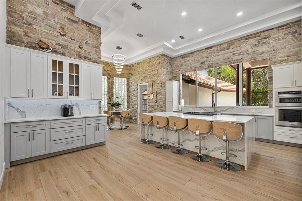 Interior, Kitchen, Marble Walls, Pendant Lights, Recessed Lighting, Stainless Steel Appliances, Stone Walls, Wood Texture Flooring