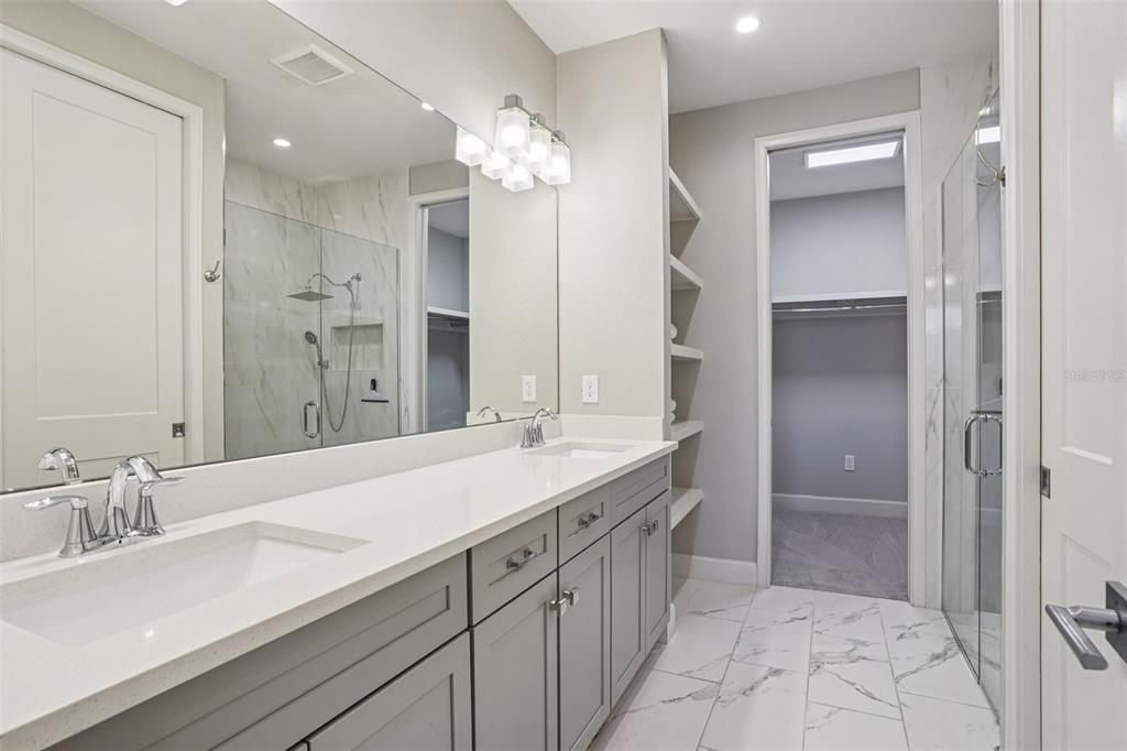 Bathroom, Dual Sink Vanities, Glass Shower, Interior, Marble, Marble Walls, Recessed Lighting, Walk-in Closets