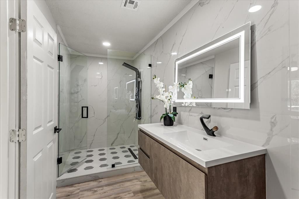Bathroom, Glass Shower, Interior, Marble Walls, Recessed Lighting, Wood Texture Flooring