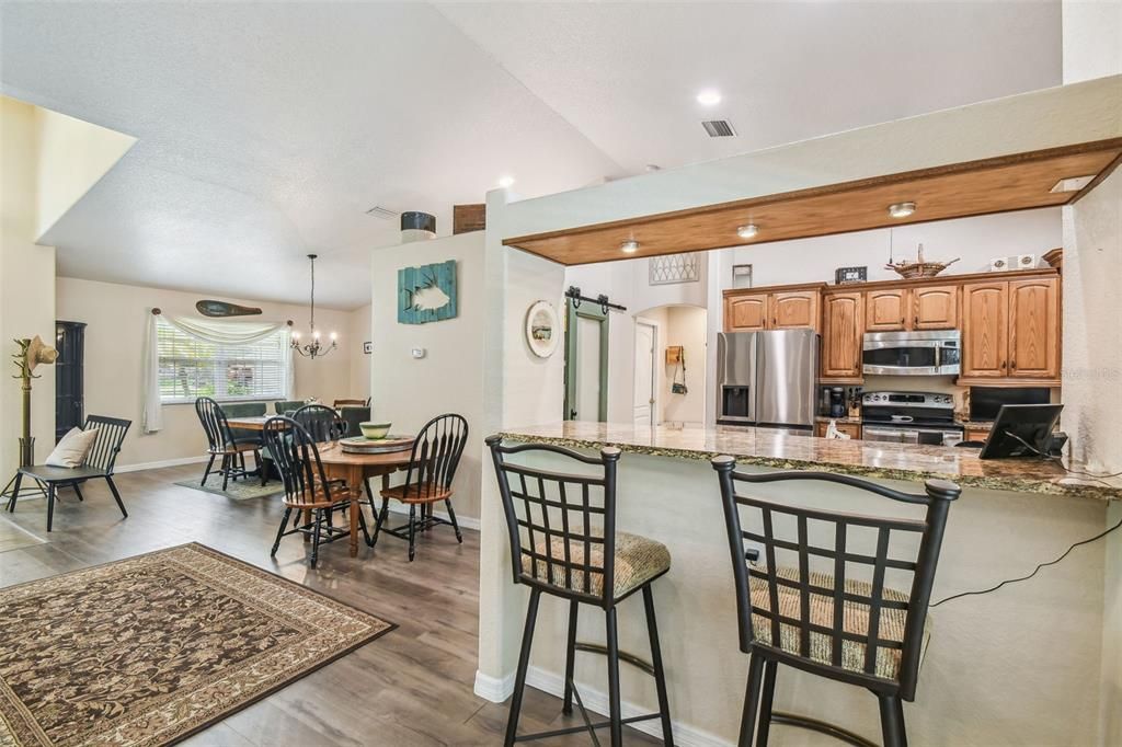 Chandelier, Dining room, Interior, Kitchen, Pendant Lights, Recessed Lighting, Stainless Steel Appliances, Wood Texture Flooring