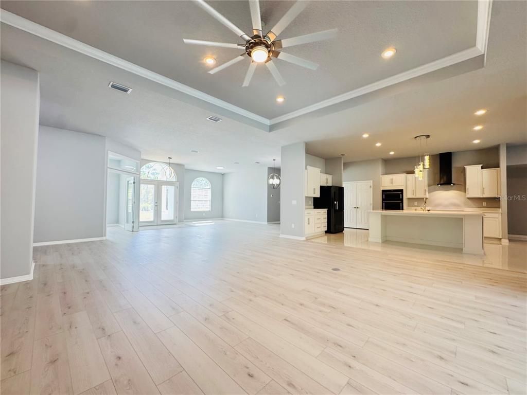 Empty room, Interior, Kitchen, Pendant Lights, Recessed Lighting, Stainless Steel Appliances, Wood Texture Flooring
