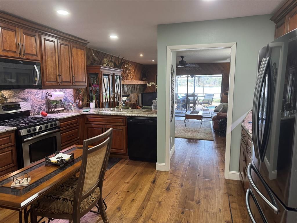 Dining room, Interior, Kitchen, Recessed Lighting, Stainless Steel Appliances, Wood Texture Flooring