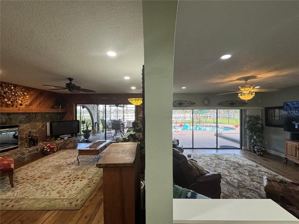 Fireplace, Interior, Living room, Recessed Lighting, Stone Walls, Wood Texture Flooring