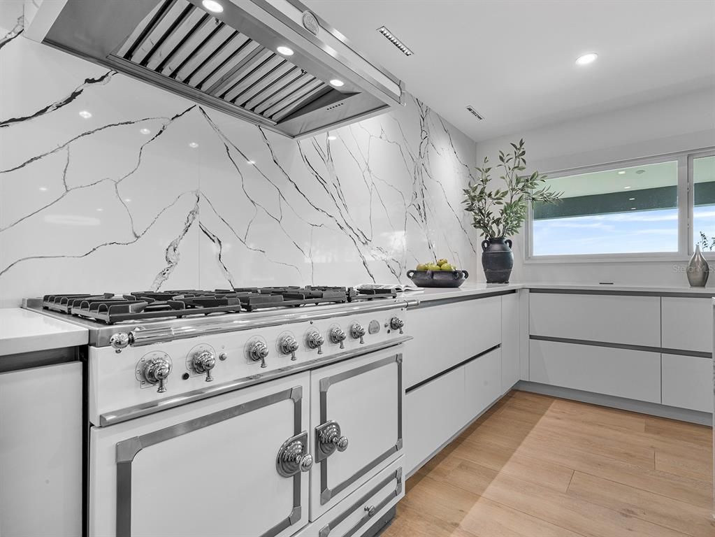 Interior, Kitchen, Marble Walls, Recessed Lighting, Stainless Steel Appliances, Wood Texture Flooring
