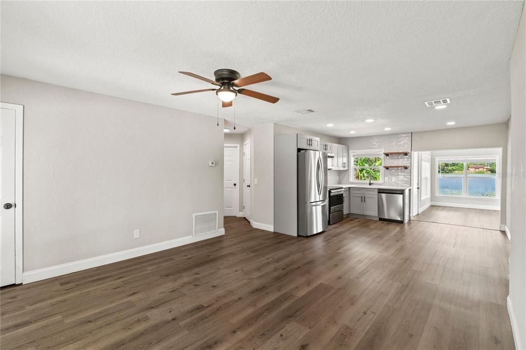 Empty room, Interior, Kitchen, Recessed Lighting, Stainless Steel Appliances, Wood Texture Flooring
