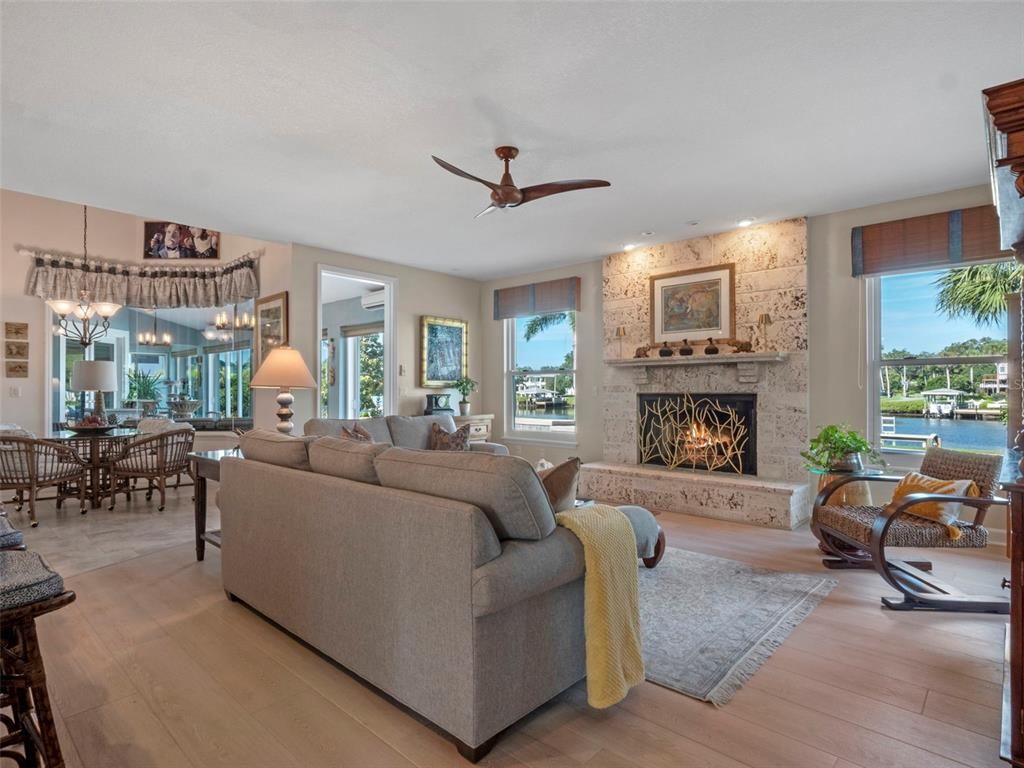Dining room, Fireplace, Interior, Living room, Pendant Lights, Stone Walls, Water, Wood Texture Flooring