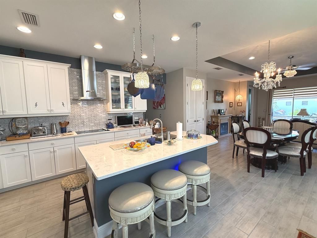 Chandelier, Dining room, Interior, Kitchen, Pendant Lights, Recessed Lighting, Stainless Steel Appliances, Wood Texture Flooring