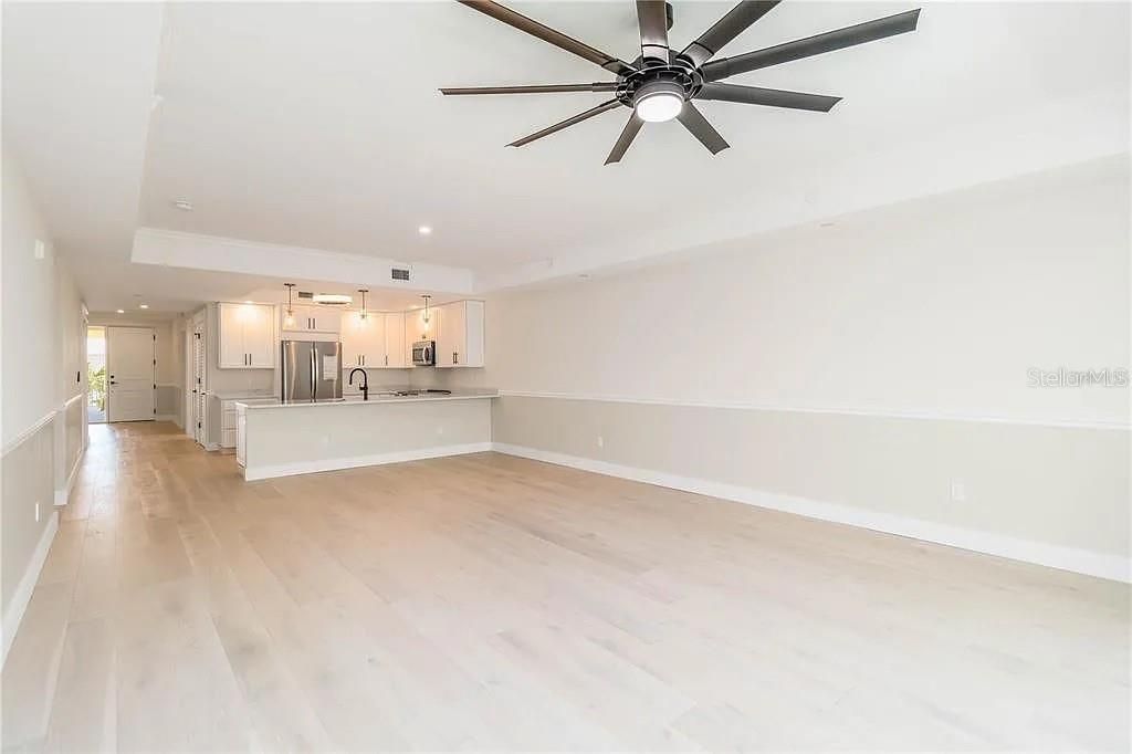 Empty room, Interior, Kitchen, Recessed Lighting, Stainless Steel Appliances, Wood Texture Flooring