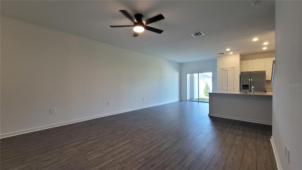 Empty room, Interior, Kitchen, Recessed Lighting, Stainless Steel Appliances, Wood Texture Flooring
