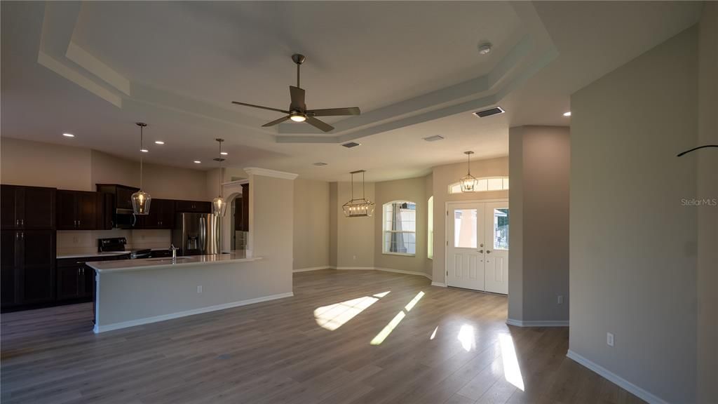 Chandelier, Empty room, Interior, Kitchen, Pendant Lights, Recessed Lighting, Stainless Steel Appliances, Wood Texture Flooring
