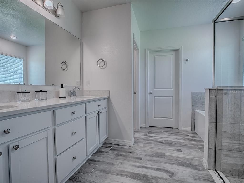 Bathroom, Dual Sink Vanities, Glass Shower, Interior, Recessed Lighting, Wood Texture Flooring