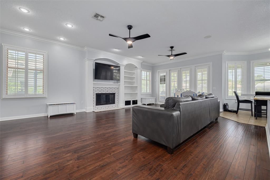 Dining room, Fireplace, Interior, Living room, Recessed Lighting, Wood Texture Flooring