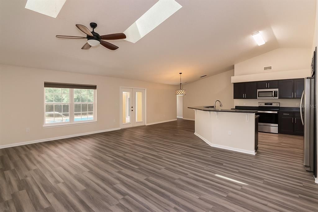 Chandelier, Empty room, Interior, Kitchen, Pendant Lights, Stainless Steel Appliances, Wood Texture Flooring