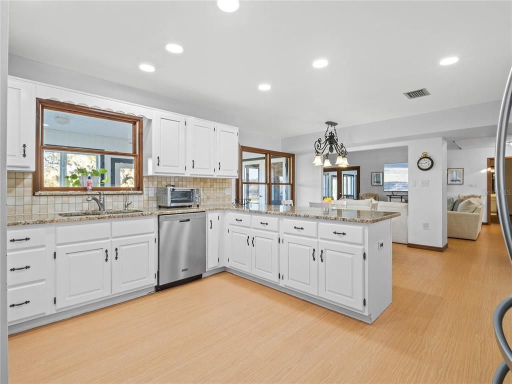Interior, Kitchen, Pendant Lights, Recessed Lighting, Stainless Steel Appliances, Tile Countertops, Wood Texture Flooring