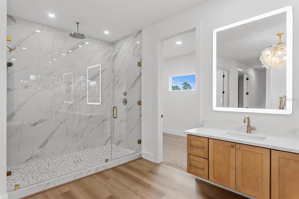 Bathroom, Glass Shower, Interior, Marble Walls, Pendant Lights, Recessed Lighting, Wood Texture Flooring