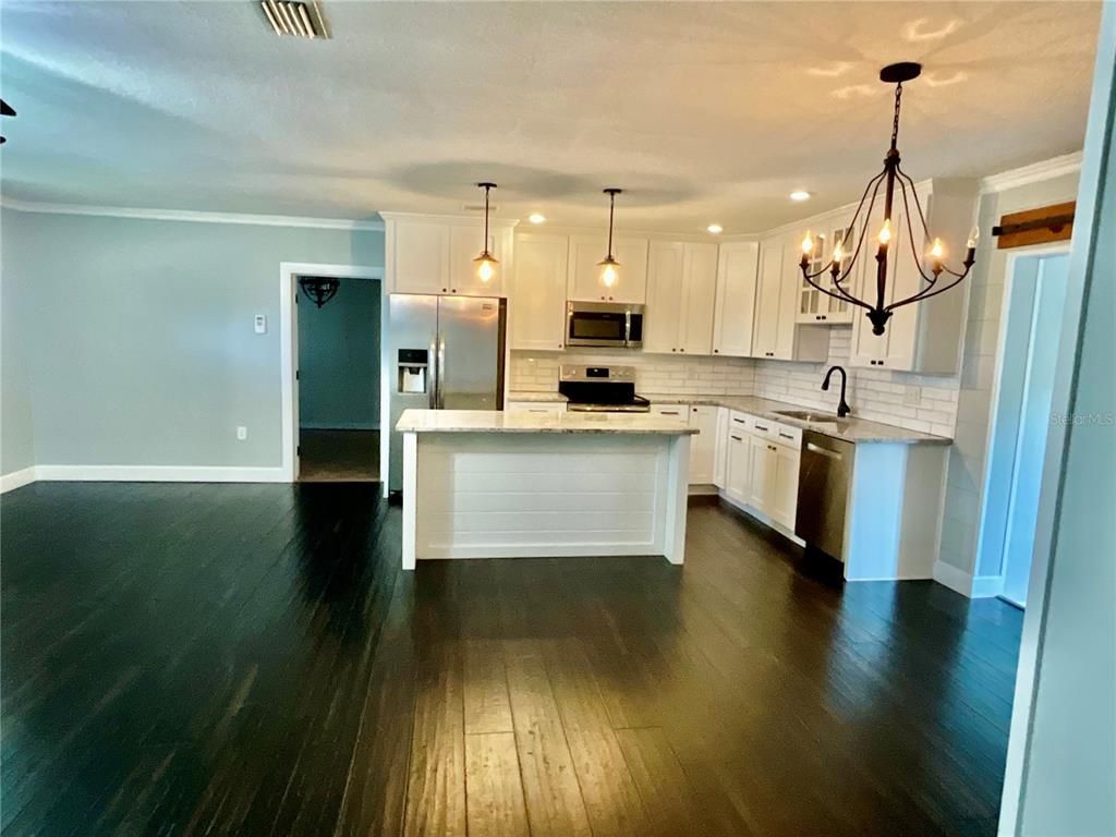 Chandelier, Interior, Kitchen, Pendant Lights, Recessed Lighting, Stainless Steel Appliances, Wood Texture Flooring