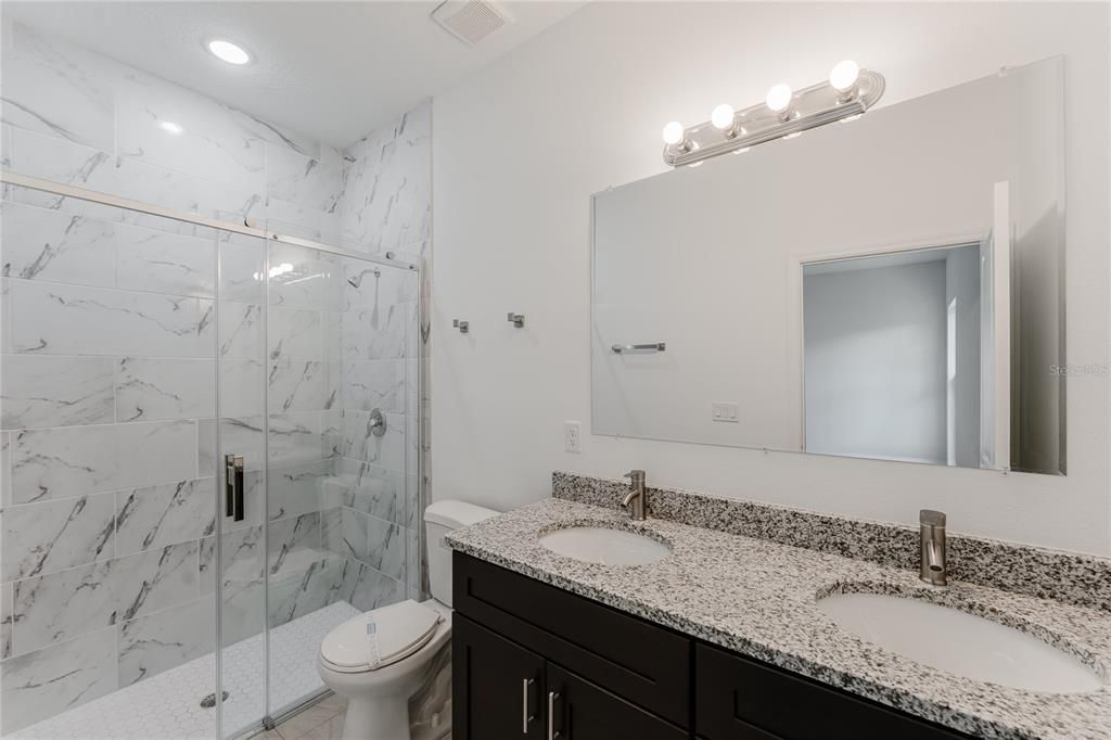 Bathroom, Dual Sink Vanities, Glass Shower, Interior, Marble Walls, Recessed Lighting